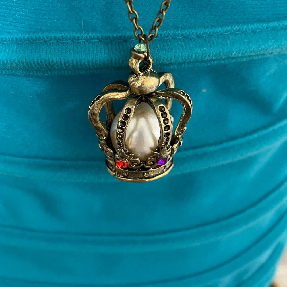 Beautiful crown necklace with long chain.